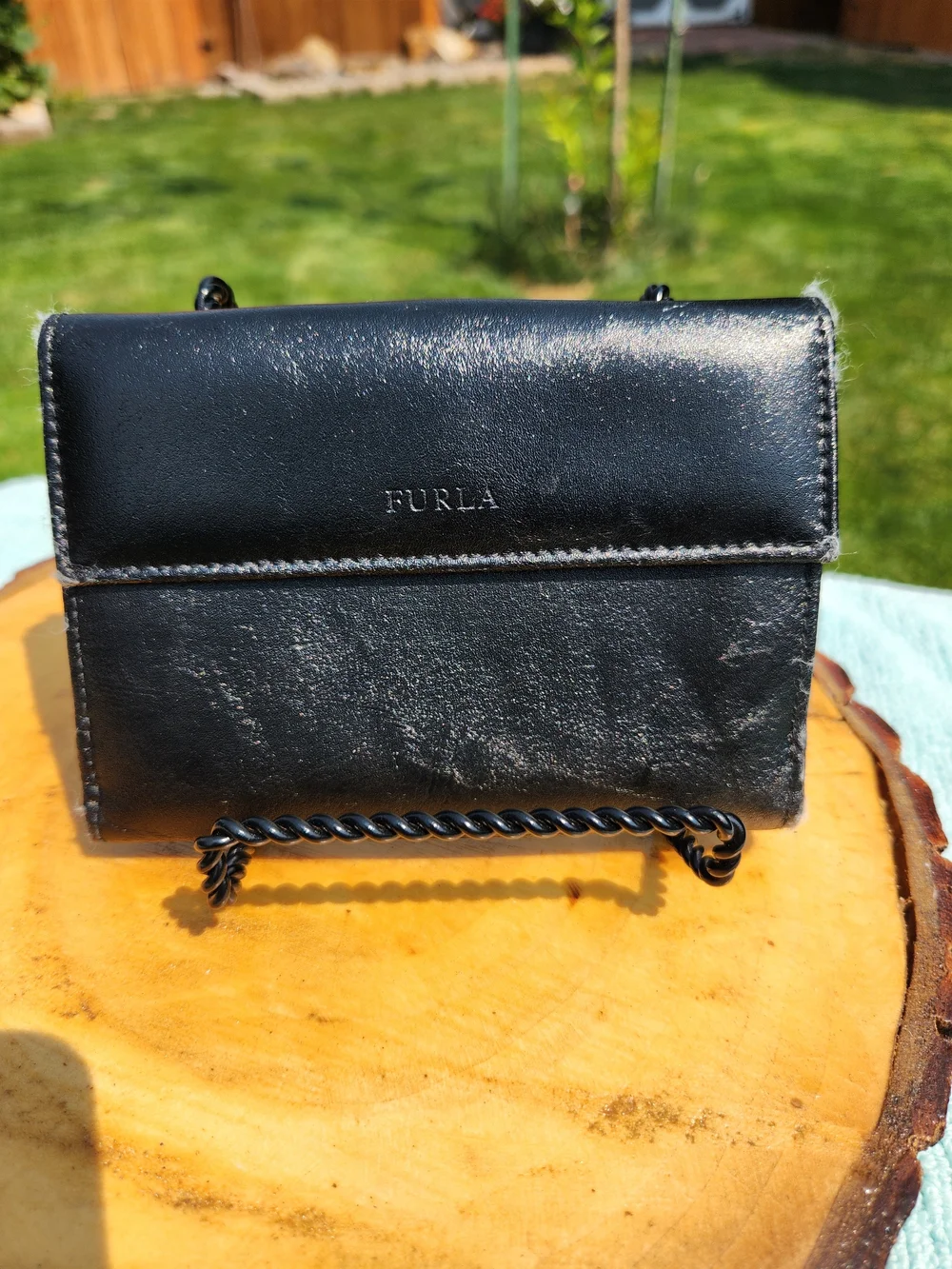 Authentic Furla trifold Compact wallet crafted from smooth black leather.